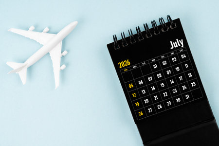 July 2026 black calendar and airplane toy on blue background.の写真素材