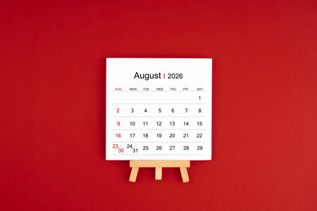 Calendar page for August 2026 with wood easel on a red background.