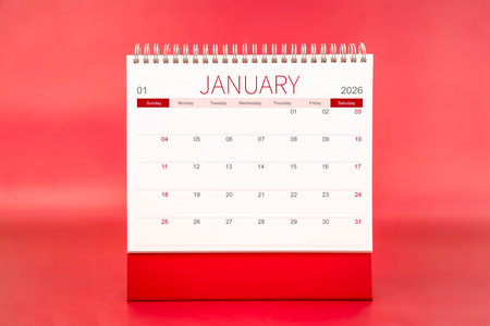 January 2026 blank desk calendar on red background.の写真素材