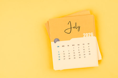 July 2026 calendar card on yellow background with copy space.