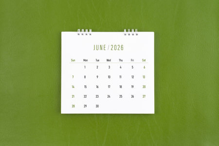 June 2026 Monthly desk calendar on green leather background.の写真素材