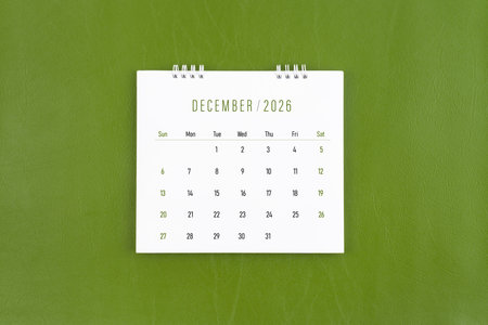 December 2026 Monthly desk calendar on green leather background.の写真素材