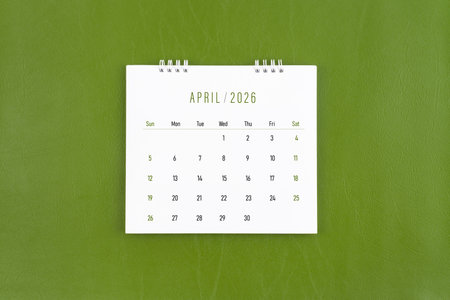 April 2026 Monthly desk calendar on green leather background.の写真素材