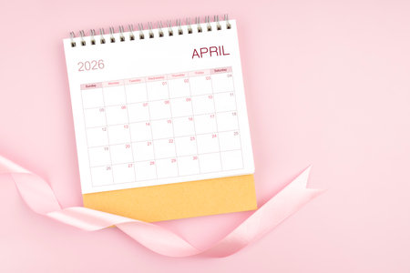 April 2026 desk calendar with pink pastel color ribbon.の写真素材