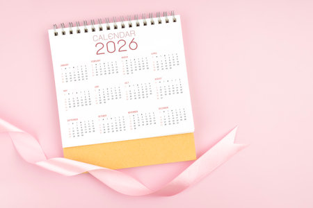 2026 Yearly desk calendar with pink pastel color ribbon.の写真素材