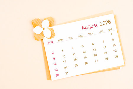 August 2026 calendar with origami flower paper on beige background.の写真素材