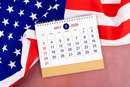 May 2026 Monthly desk calendar and United States of America flag on red wooden.の写真素材