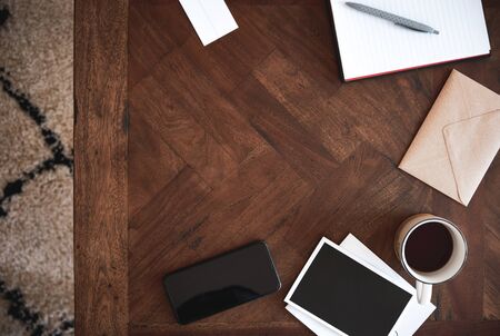 Coffee table with space in middle with mobile phone.の写真素材