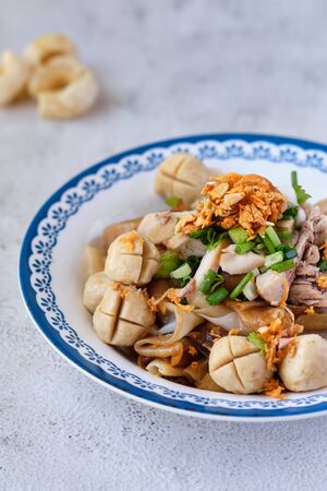 Thai beef noodles in a bowl on rustic table.の写真素材