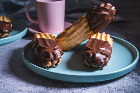 Dark chocolate coated tasty half digestive biscuit with chocolate cookies and chips for loved ones valentines day celebration. Partially eaten with crumbs. side view.の写真素材