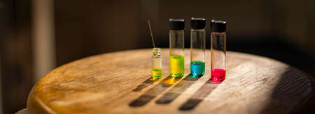 Colourful solutions in different vial with capillary under the light in a chemistry laboratory for healthcare researchの写真素材