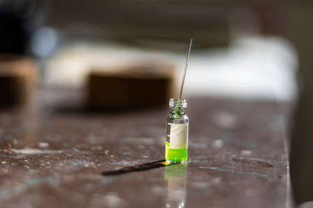 Colourful reagents in LCMS vial with capillary on UV light in a biotechnology laboratory for Pharmaceutical research for medicine developmentの写真素材