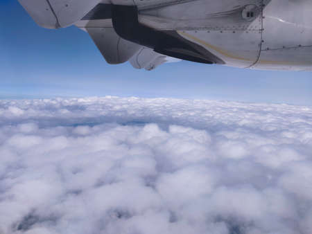 Landscape View of flight propeller and floating cloud from flight window in high altitude during the travel in Europe during the summerの写真素材