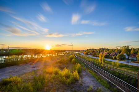 A beautiful landscape view of cloud movement during the evening with golden sunbeam from horizonの写真素材