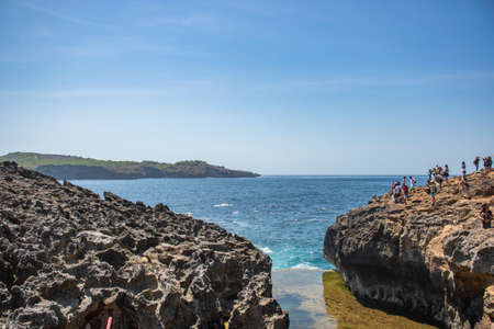 A seascape of Broken beach shore aqua water wave from the top during the summer day touristic visit...