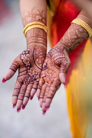 Bengali marriage rituals with beautiful decoration of hand with hena for bride and groom in Indian weddingの写真素材