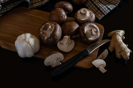 Homemade Fresh stack of organic champignon mushrooms isolated from background with clipping knive and full depth of field. preparation for dinner.の写真素材