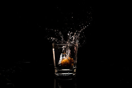 High resolution natural water splash freeze motion from a clean glass of water with droplet and...