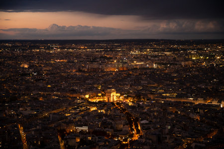 High Resolution Panorama Of Paris Skyline from Eiffel Tower during rainy sunset. Night time light from the city roads and buildings.の写真素材