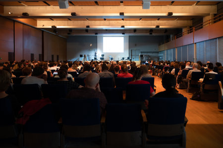 People attending to an European scientific conference. A huge gathering of people meeting for scientific discussion.の写真素材