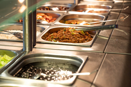 Asian food buffet in restaurant multiple food dishes and salad. Eat as much as you like buffet...