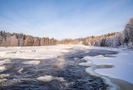Winter Landscape with snowy Trees and Calm Winter River. Winter Forest On The River At Sunset.の写真素材