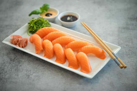 Fresh Sushi Roll with salmon, eel, tuna, avocado, royal prawn, cream cheese, caviar tobica, chuka. Sushi menu. Japanese food. Copyspace black background.の写真素材