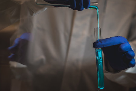 Female chemistry scientist doing experiments in lab. Pipette adding colorful solution in tubes, medical abstract background.の写真素材