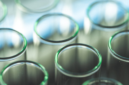 Female chemistry scientist doing experiments in lab. Pipette adding colorful solution in tubes,...