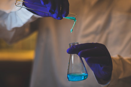 Female chemistry scientist doing experiments in lab. Pipette adding colorful solution in tubes, medical abstract background.の写真素材