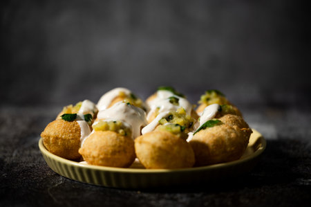 Panipuri, famous street food in India. Other names are fuchka, gupchup or golgappa. Filled with mash...