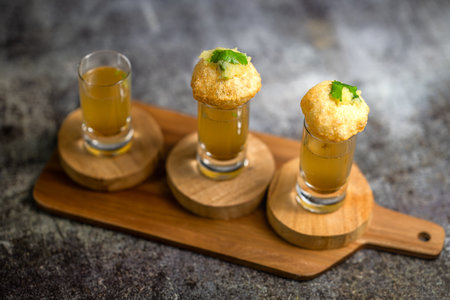 Panipuri, famous street food in India. Other names are fuchka, gupchup or golgappa. Filled with mash...