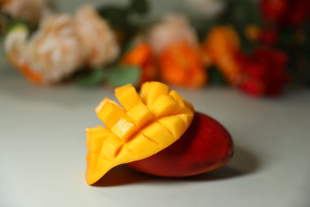 Mango fruit on the table with flower background, selective focus.の写真素材