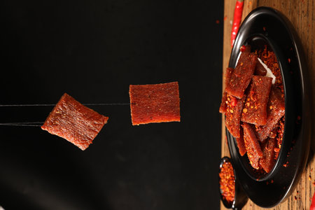 Dried paprika sticks in bowl on wooden table, closeupの写真素材