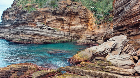 Beach with rocks, beautiful landscape of the beach in Rio de Janeiro, the stones are carved by water and wind.の写真素材