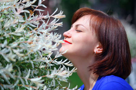 The girl in park feels the smells of spring forgotten for a winterの写真素材