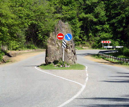 Obstacle in the form of a rock on mountain roadの写真素材