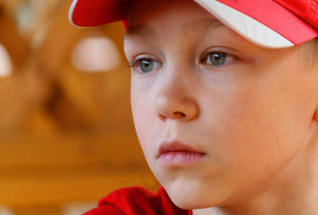 The boy watches in a cap with interest on representationの写真素材