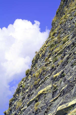 Rocky slope of mountain in cloudsの写真素材