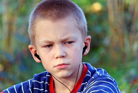 Teenager listens to music in headphones with a playerの写真素材