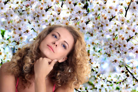 Girl on the background of cherry blossomsの写真素材