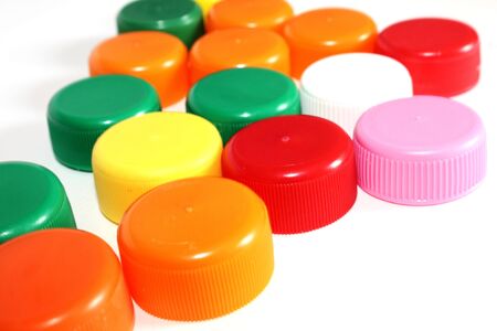 colorful bottle lids on white background