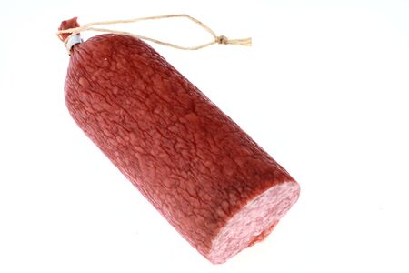 half paprika salami isolated on white backgroundの写真素材