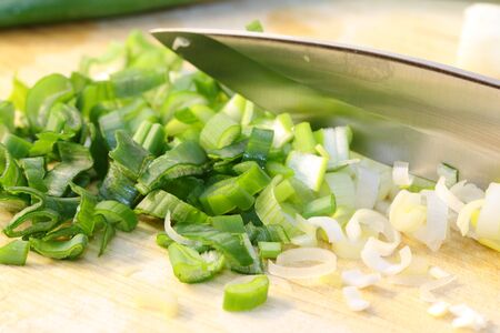 finely sliced leeks with knife on desk