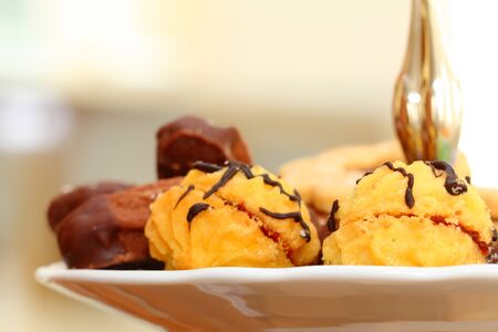 close up of chocolate sweets on white plate