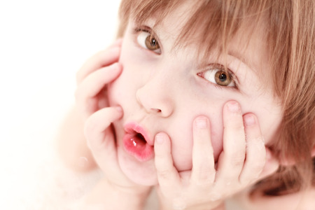 astonishment - close up of cute young girl face in bathの写真素材