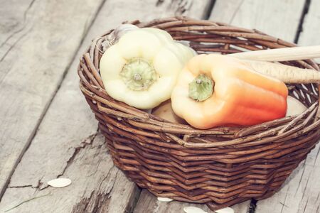 autumn vegetables in basket on wood deskの写真素材