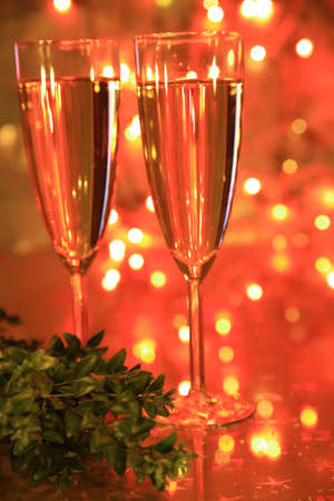 Champagne in glasses,green twig and twinkle lightsの写真素材
