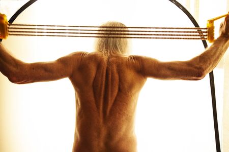 Old  adult getting exercises with rubber.の写真素材