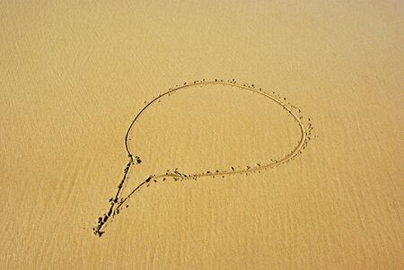 a blank dream / think bubble drawn on the sand as a backgroundの写真素材